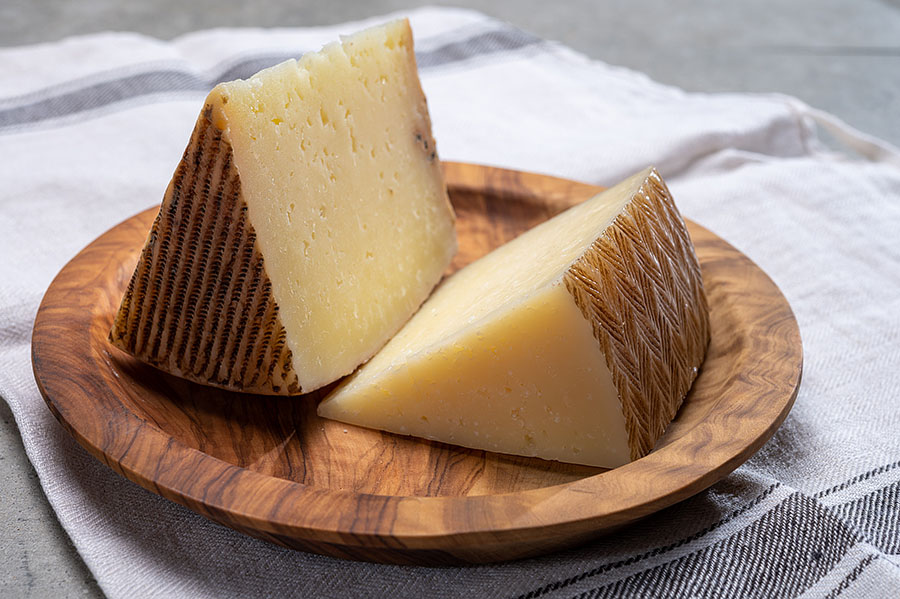 manchego cheese on a round cheese board