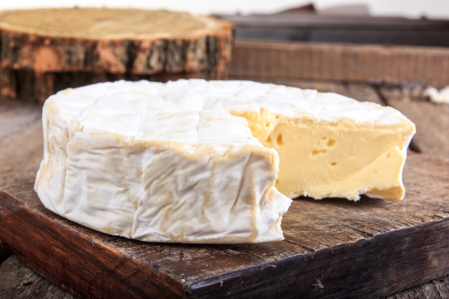 tripple cream brie on a wood cheese board