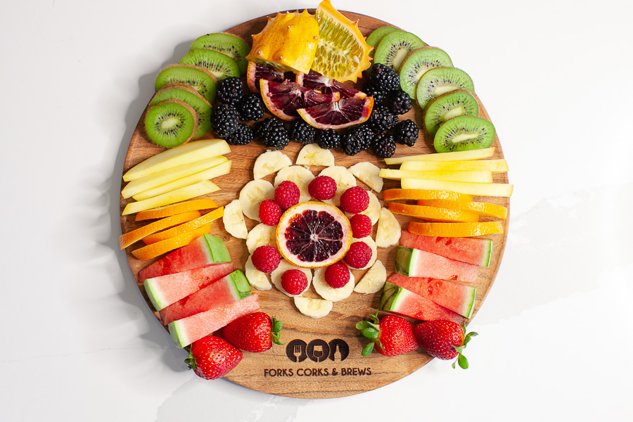 round charcuterie board with fresh fruit