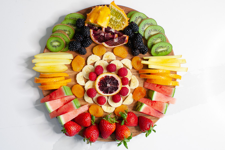 round charcuterie board with fresh fruit