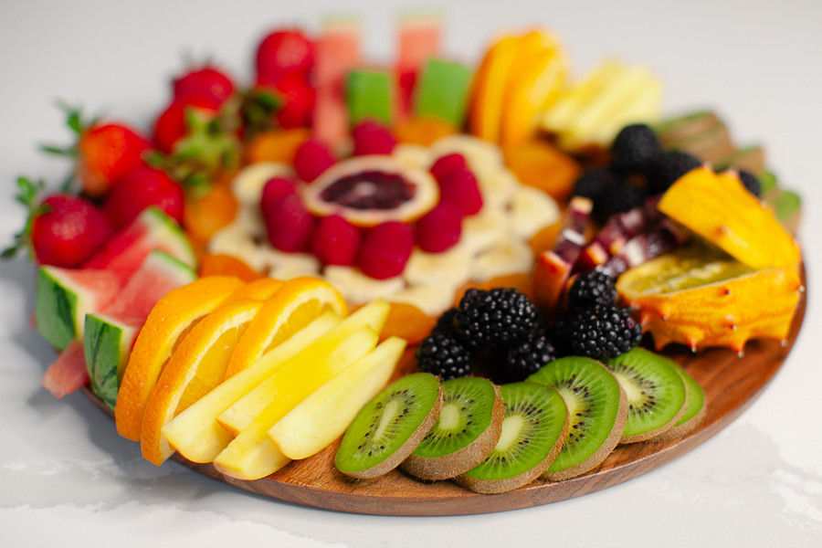 round charcuterie board with fresh fruit