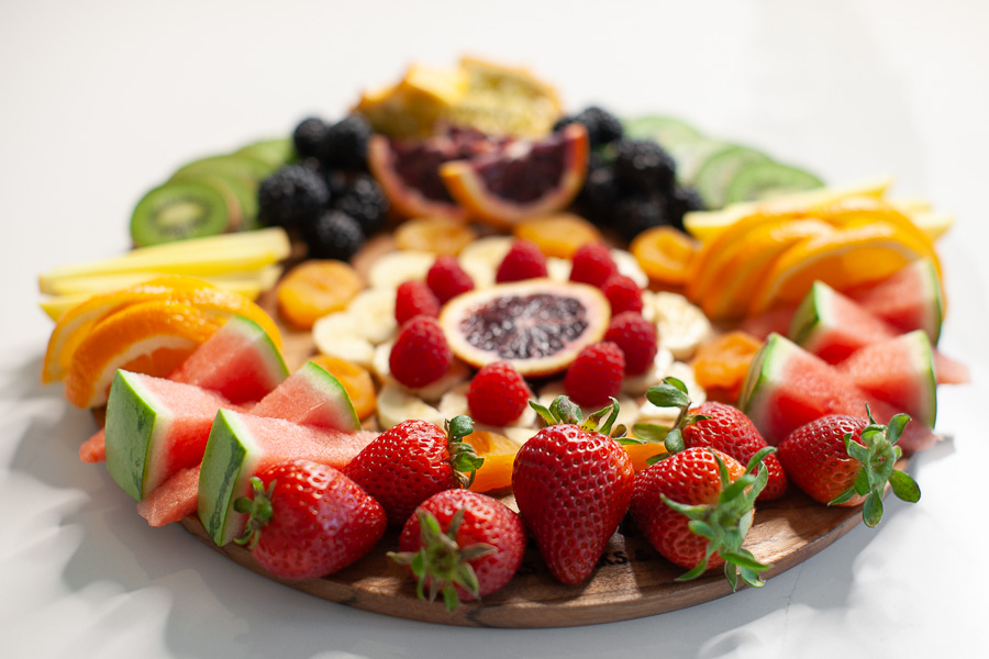 round charcuterie board with fresh fruit